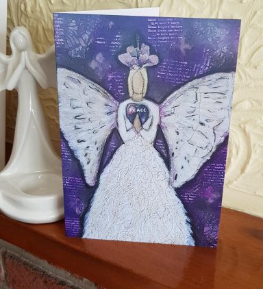 A decorative card featuring an angel with white wings and a purple background.